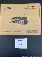 Original cardboard packaging box of Lepy LP-V9S Hi-Fi Fashion Mini Power Amplifier listing main features like Bluetooth 25W x 2 RMS, built-in power adapter, and input options.
