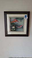 Full view of the framed 3D koi fish artwork hanging on wall, showing brown wooden frame and cream double matting.