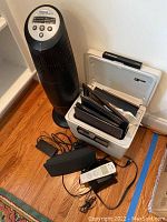 Overall shot showing the air purifier, safe with folders inside, remote control and cords.