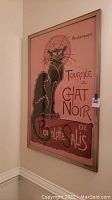 Full view of the framed 'Tournee Du Chat Noir' poster print hanging on a wall.