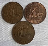 Reverse side of the three Canadian half pennies showing the detailed sailing ship design and dates 1951, 1956, and 1965.