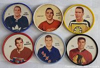 Top down view of six round hockey coins from the 1960-62 NHL era featuring player images and names