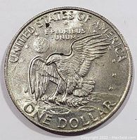 Reverse view of 1972 Eisenhower dollar coin featuring eagle landing on the Moon and inscriptions.