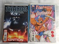 Photo showing first two comic books in lot: Thanos Imperative Ignition and Fantastic Four Unplugged, highlighting cover art and condition.