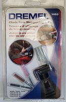 Photo showing the front of the sealed Dremel chain saw sharpening kit package with visible stones and guide attachment.