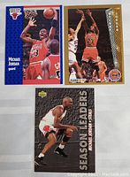 Photo of three vintage Michael Jordan basketball cards, showing different designs and action shots from early to mid 1990s.