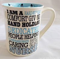 Side view of the nurse themed mug showing words and phrases such as 'I AM A HARD-WORKING COMFORT GIVING HAND HOLDING DEDICATED PEOPLE HELPING CARING NURSE'.