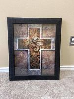Framed cross wall art with intricate scroll pattern and inspirational words in panels surrounding cross