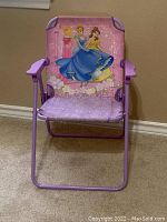Front view of purple children's folding chair with Disney Princesses featured on the backrest.