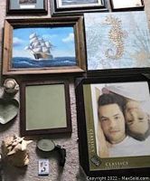 Wide view showing framed sailboat and seahorse paintings and 8x10 picture frame