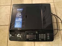 Front and top view of Brother MFC-J835DW printer showing control panel and power cords