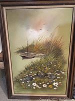 Full view of the oil landscape painting with boat, grasses, and flowers in frame.