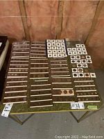 Twelve clear sleeves laid out on table showing rows of assorted coins in cardboard flips and pockets