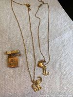 Overview of brooch and two pendant necklaces