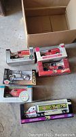 Seven boxed die-cast model trucks with Canadian Tire branding and various vehicle types including vintage delivery vans and promotional racing trucks.