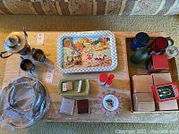 Overview of all included items laid out on carpet, showing silver platter, candles, lighters, ashtrays, collectible tray, and boxes.