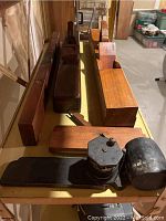 Multiple wooden planes and level arranged on metal shelving