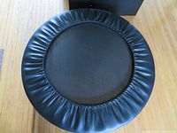 Top view of the mini trampoline showing black padded outer ring and black jumping mat surface.