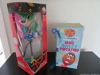 Two vintage toys: Thinkway Dancing Doll in box and Mr. Potato Head 50 Years commemorative trivia book box.