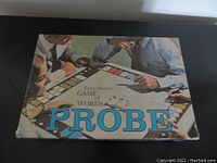Top view of the closed game box showing vintage cover art depicting four men playing the Probe game with large blue title text.