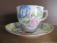 Close-up front view of Salisbury Fine Bone China teacup with multicolor floral decoration and gold accents, placed on matching saucer.