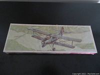 Top view of the sealed box showing illustration of Antonov AN-2 biplane in flight with detailed artwork.