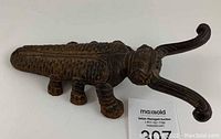 Top side view of the cast iron beetle-shaped boot jack showing the detailed body, legs, and curled antennae.