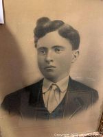 Close-up of man's portrait in sepia tone showing head and upper torso with formal clothing