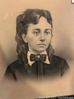 Close up of the woman's face and upper torso on the portrait, showing detailed shading and curls in hair.