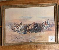 Full view of the framed print showing the buffalo hunt scene with Native American riders and buffalo.