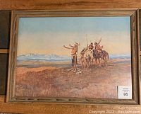 Full view of framed Charles Russell print showing Native American scene with figures on horseback and a standing figure raising an arm, set against a mountainous landscape.