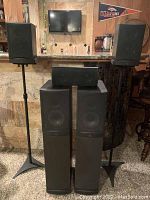 Overview of two RS4 towers, two RS1 satellite speakers on stands, and CC-1 center speaker