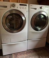 Both LG washer and dryer on matching pedestal drawers