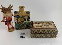 Full view of Kachina doll, old ceramic bottle, and decorative wooden box.