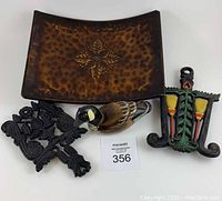 Full view of all four items including the wooden duck, two cast iron trivets, and metal centerpiece holder.