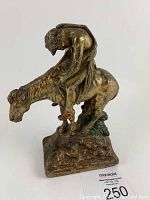 Full view of the bronze door stop showing the Native American on the horse posed slumped forward, on rectangular bronze base.