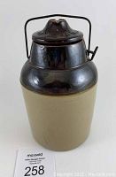 Side view of the Weir crock fruit jar showing the tan crock body and brown glazed wire bail top lid