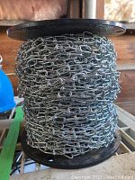 Full view of spool with tightly wound 3/4 inch chain link roll