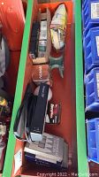 Top view of plastic tray with boxed light bulbs, flashlight, and anvil showing multiple product boxes and some loose items.