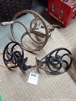 Wide angled view showing all three metal cranks with wooden handles on carpeted floor next to a red crate.