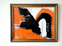 Frontal view of the framed abstract painting showing orange background with sweeping black and white strokes