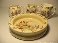 Four Royal Doulton Bunnykins ceramic tableware items: porringer bowl, two cups, and one mug arranged on white background.