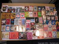 Full spread of 72 assorted playing card decks with various themes and packaging visible.