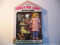 Front of the boxed Crazy Cat Lady action figure with 6 cats visible inside packaging