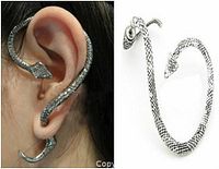 Front view of a snake shaped wrap-around ear stud earring worn on ear and separate on white background showing texture and shape.