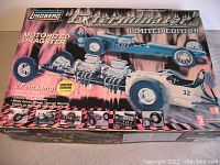 Front view of the boxed Lindberg Exterminator motorized dragster model kit showing box art, branding, and features.