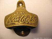 Front view showing embossed 'Drink Coca-Cola' logo and top screw hole.