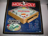 Front of box showing Monopoly and Sorry branding with image of wooden chest and game board setup