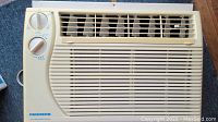 Front view of Fedders air conditioner showing front grille and control dials.