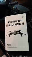 English instruction manual featuring the drone image and model E58 branding.
